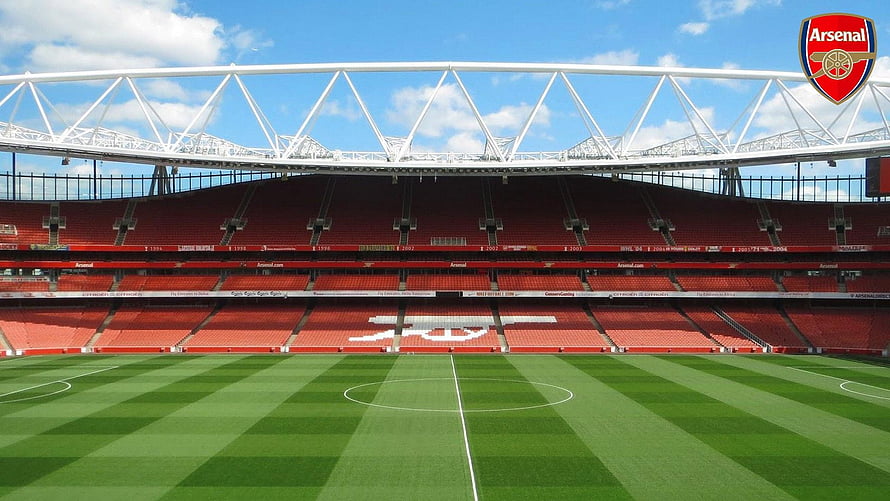 Emirates Stadium Interior View With Arsenal Crest And Red Seating HD wallpaper