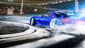 Blue sports car drifting through a smoke-filled urban street at night with motion blur HD wallpaper
