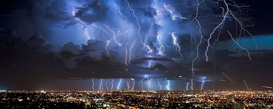 Dramatic Night Lightning Storm Over a Glowing City Skyline HD wallpaper