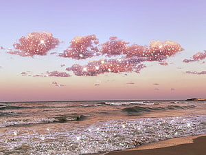 Dreamy Pastel Beach at Dusk with Glittering Sparkles on Ocean Waves and Clouds HD wallpaper