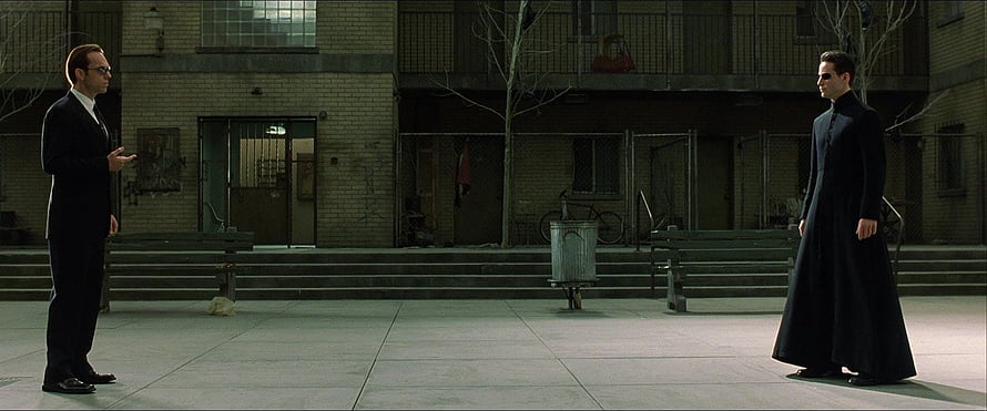 Neo and Agent Smith Confrontation in the Matrix Courtyard Scene HD wallpaper
