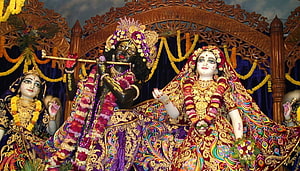 Iskcon Mayapur Deities: Krishna Playing Flute with Radha and Lakshmi in Ornate Temple Setting HD wallpaper
