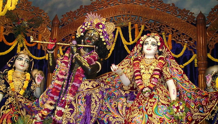 Iskcon Mayapur Deities: Krishna Playing Flute with Radha and Lakshmi in Ornate Temple Setting HD wallpaper