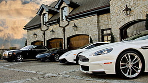 Luxury Supercars Parked in Front of a Grand Stone Mansion at Dusk HD wallpaper