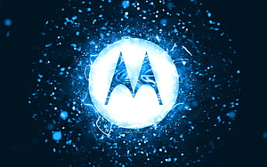 Glowing Motorola Logo Set Against a Dynamic Blue Particle and Light Burst Background HD wallpaper