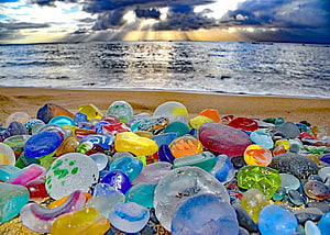 Colorful Sea Glass Collection on a Sandy Beach with Dramatic Ocean Sky HD wallpaper