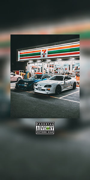 White Toyota Supra and Blue Nissan Skyline parked at a 7-Eleven at night HD phone wallpaper