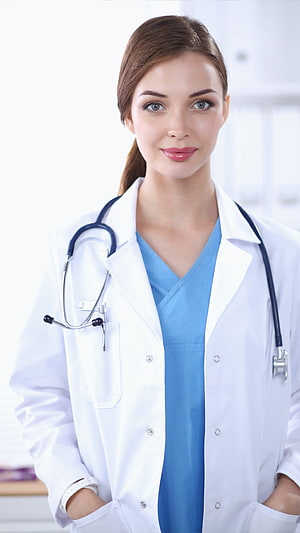 Smiling Female Doctor in White Coat and Blue Scrubs with Stethoscope HD phone wallpaper