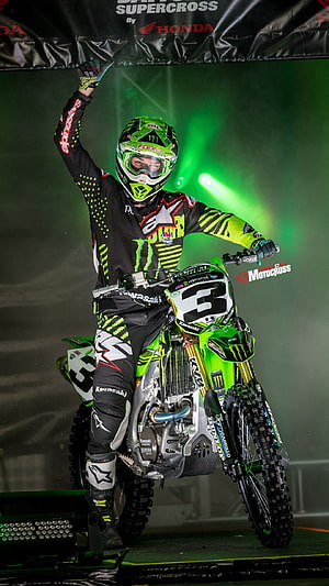 Kawasaki Monster Energy Supercross Rider Celebrating Victory on Stage HD phone wallpaper