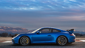 Blue Porsche 911 GT3 RS side profile on a track with mountain backdrop at dusk HD wallpaper