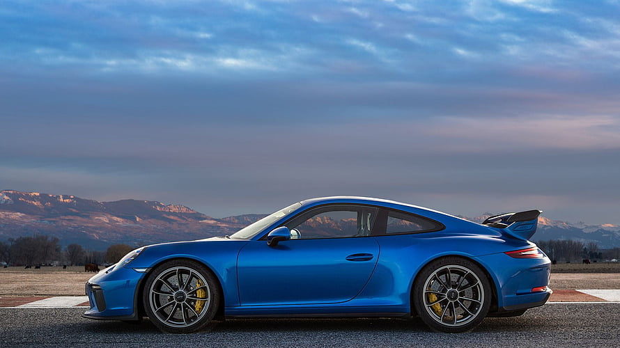 Blue Porsche 911 GT3 RS side profile on a track with mountain backdrop at dusk HD wallpaper