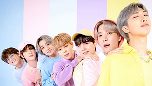 BTS Group Portrait in Pastel Colors with Playful Expressions and Casual Outfits HD wallpaper
