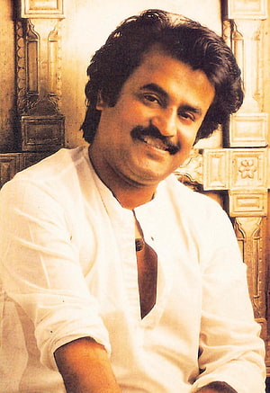 Rajinikanth Portrait in White Kurta with Ornate Carved Wooden Background HD phone wallpaper