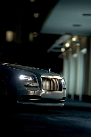 Rolls-Royce Front Grille and Headlights Illuminated at Night in a Luxury Setting HD phone wallpaper