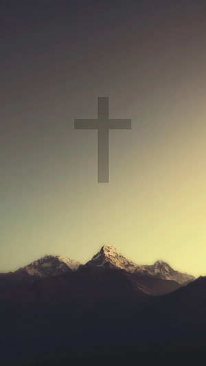 Minimalist Christian Cross Floating Above Snow-Capped Mountain Peaks at Golden Hour HD phone wallpaper