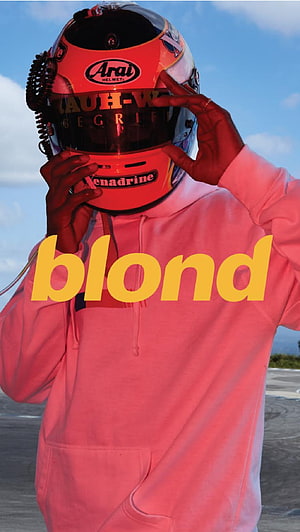 Frank Ocean in racing helmet and pink hoodie with bold blond text overlay HD phone wallpaper