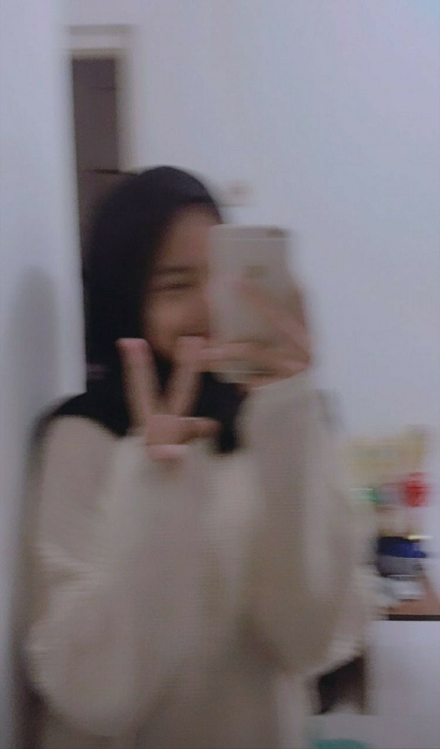 Candid Mirror Selfie of a Woman in a Cream Sweater Making a Peace Sign HD phone wallpaper