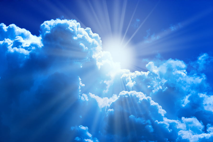 Bright Sunburst Breaking Through Fluffy Cumulus Clouds in a Deep Blue Sky HD wallpaper