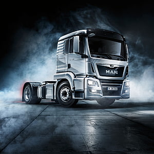 MAN TGX Heavy Duty Semi Truck in Dramatic Studio Smoke HD phone wallpaper