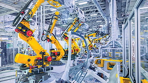 Yellow Robotic Arms Assembling Car Body In Modern Automated Factory HD wallpaper