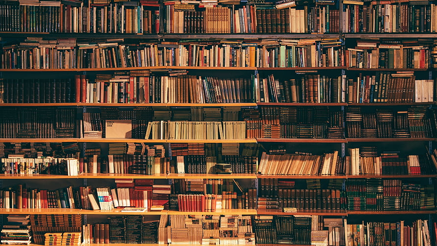 Vintage Library Bookshelves Filled With Old Hardcover Books HD wallpaper