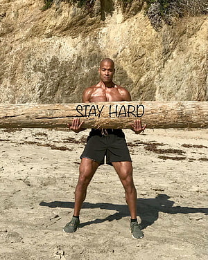 David Goggins Carrying Log on Beach with Stay Hard Message HD phone wallpaper