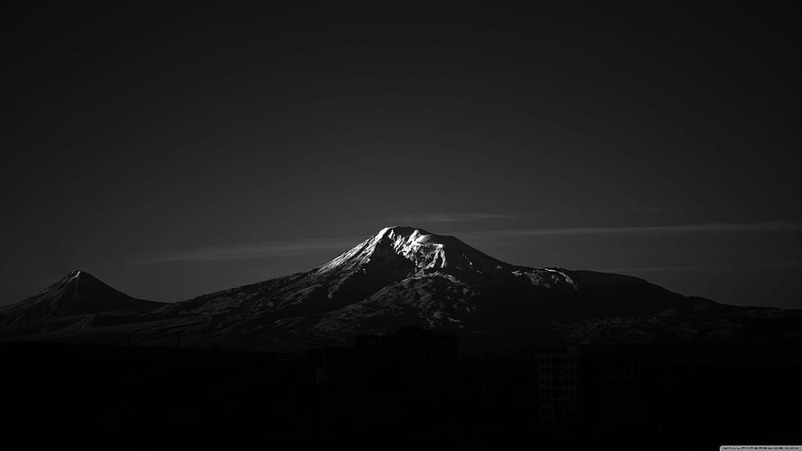 Dramatic Black and White Snow-Capped Mountain Peak at Night HD wallpaper