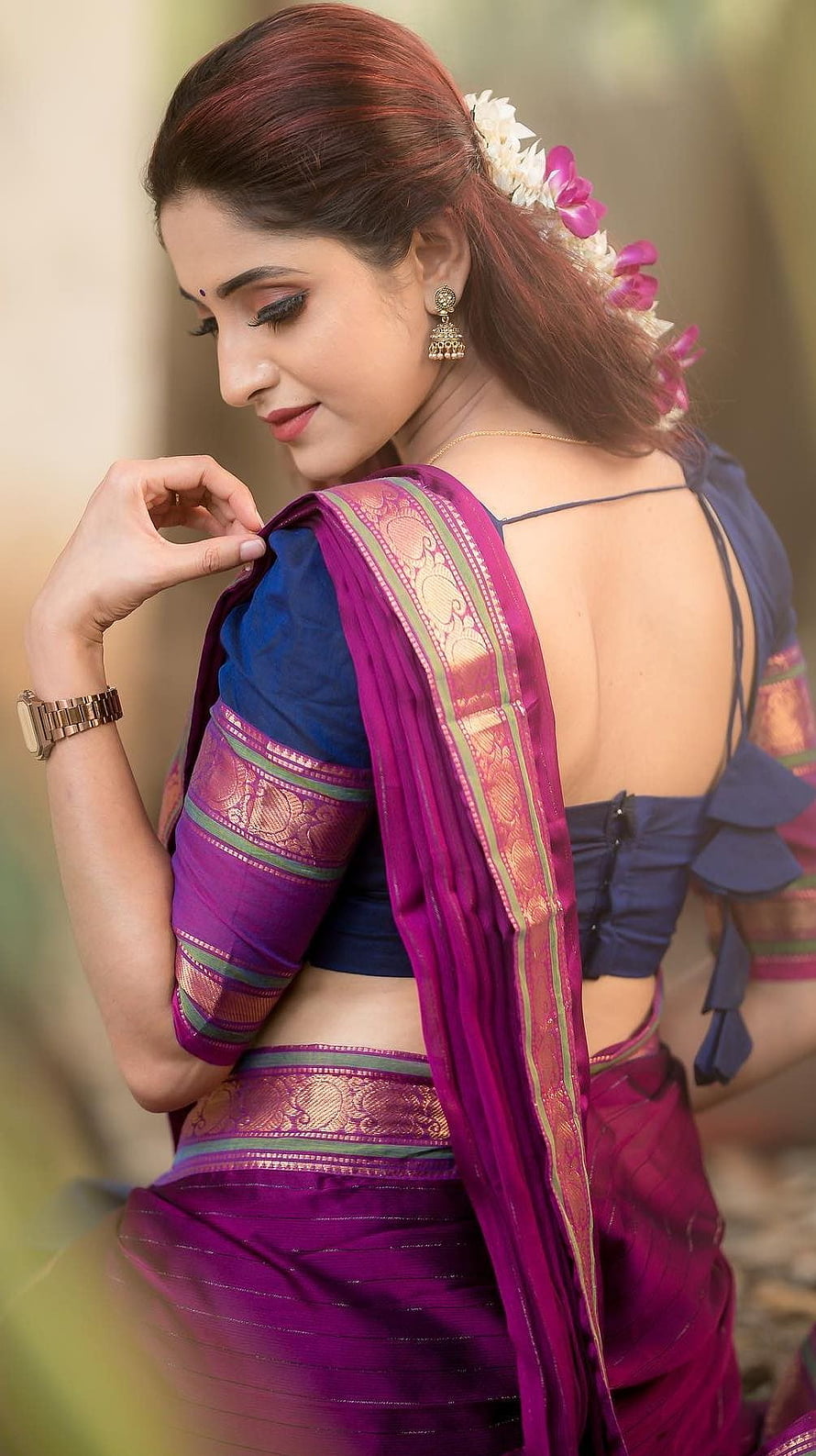 Ayesha in a vibrant purple and blue saree with floral hair accessories and traditional gold jewelry HD phone wallpaper
