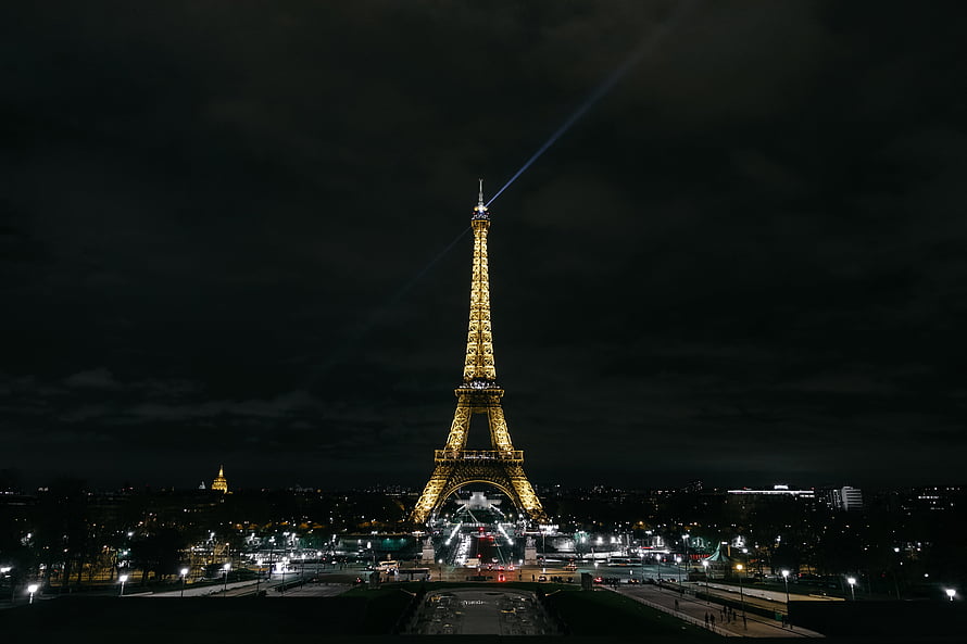 Eiffel Tower Illuminated Against Dark Night Sky in Paris France HD wallpaper