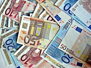 Scattered Euro Banknotes Featuring 10, 20, and 50 Denominations in a Close-Up Financial Composition HD wallpaper