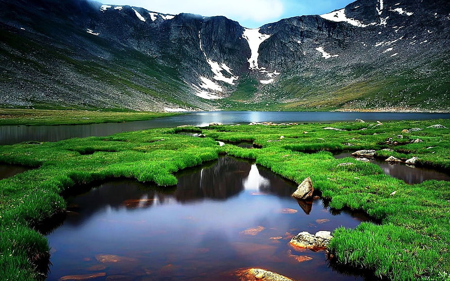 Alpine Tarn and Mossy Wetland in a Snow-Capped Mountain Valley HD wallpaper
