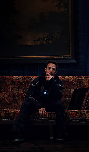 Tony Stark in a dimly lit room with an ornate tapestry and a large landscape painting HD phone wallpaper