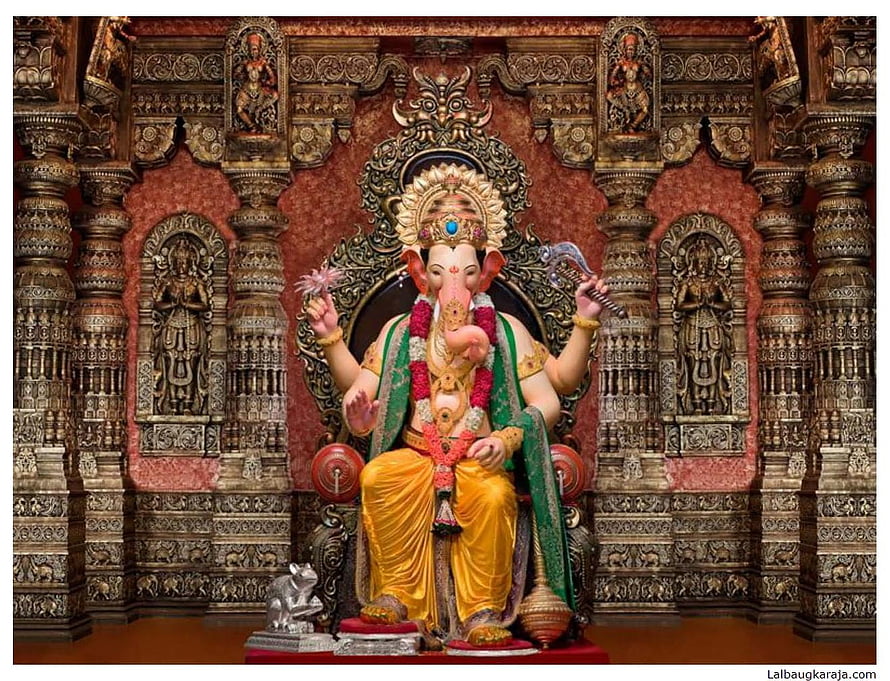 Lalbaugcha Raja Ganesha Murti in Ornate Temple Setting with Gold Drape and Floral Garland HD wallpaper