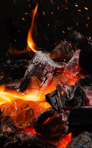 Glowing Campfire Embers and Rising Sparks in the Dark HD phone wallpaper