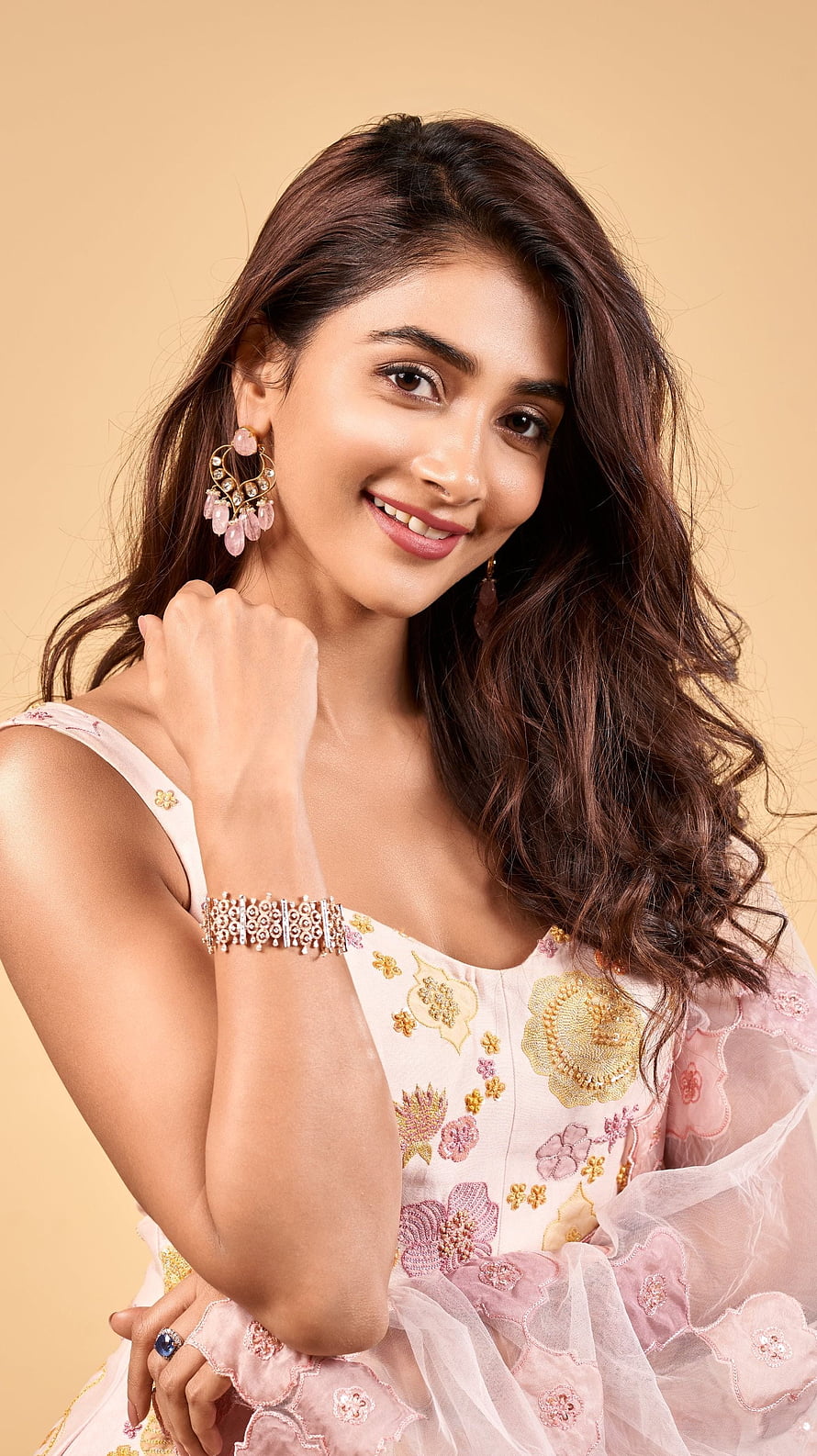Pooja Hegde in a pink embroidered gown with gold jewelry and wavy hair HD phone wallpaper