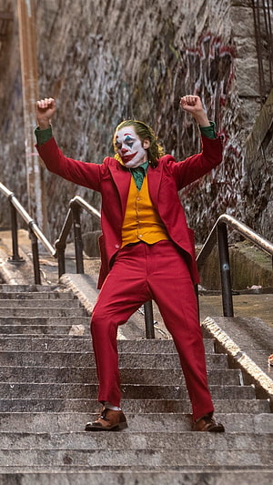 Joker Dancing on Stairs in Red Suit with Clown Makeup HD phone wallpaper