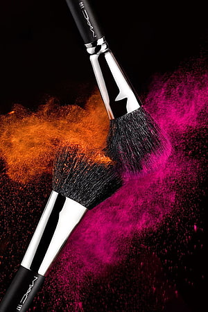 MAC Professional Makeup Brushes with Vibrant Orange and Pink Powder Explosion on Black Background HD phone wallpaper