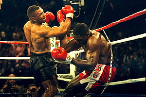 Mike Tyson Delivers Knockout Punch in Classic Boxing Match HD wallpaper