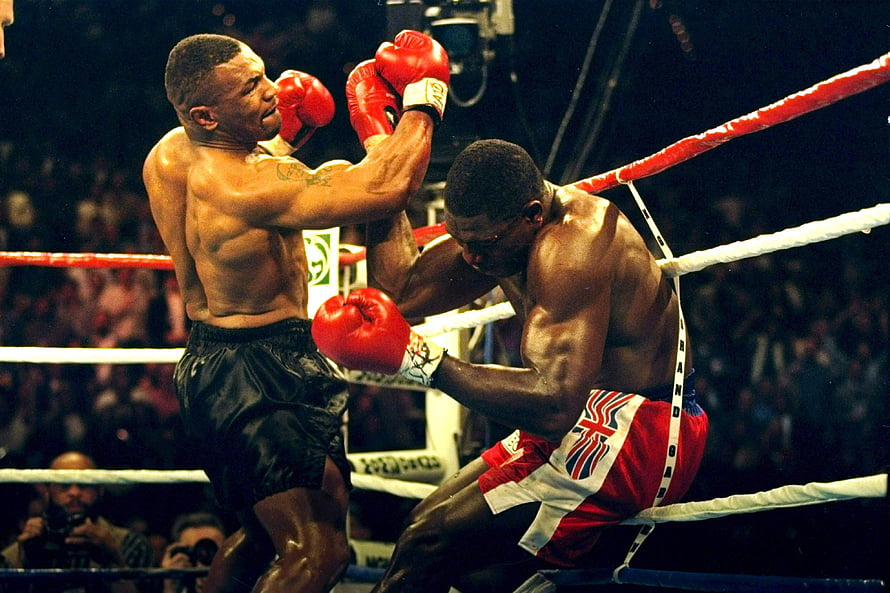 Mike Tyson Delivers Knockout Punch in Classic Boxing Match HD wallpaper