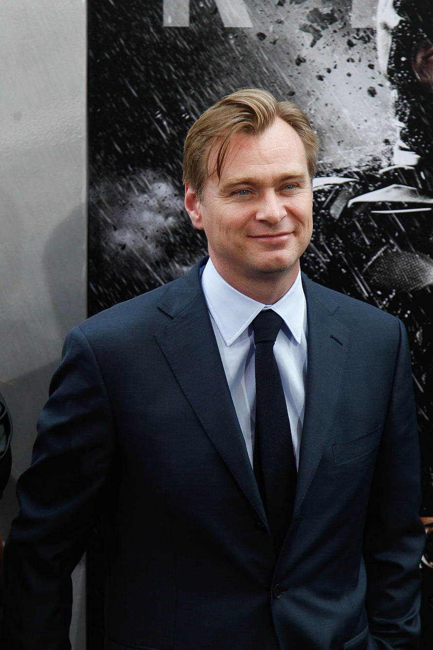 Christopher Nolan in a dark suit and tie at a formal event HD phone wallpaper