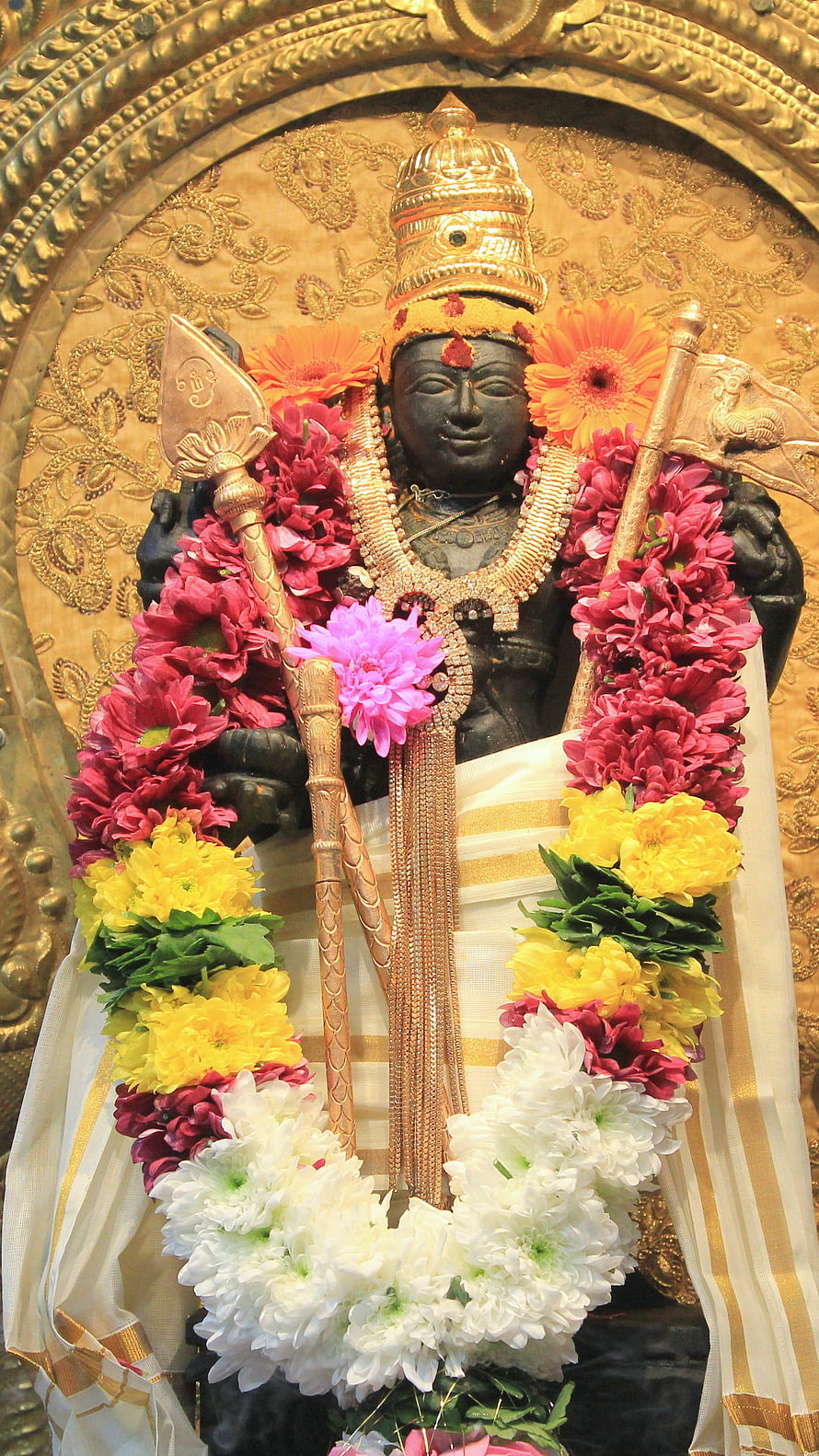 Lord Murugan Temple Idol Adorned With Colorful Flower Garlands And Golden Crown HD phone wallpaper