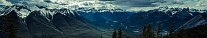 Panoramic View of Snow-Capped Rocky Mountain Range and Valley HD wallpaper