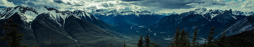 Panoramic View of Snow-Capped Rocky Mountain Range and Valley HD wallpaper