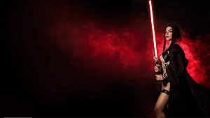 Female Sith Lord Cosplay with Red Lightsaber in Dark Smoky Atmosphere HD wallpaper