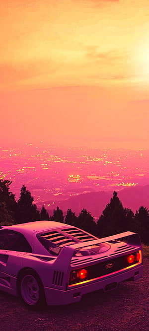 Retro Outrun Aesthetic: Classic Sports Car on a Hilltop at Sunset with Neon Pink Sky HD phone wallpaper