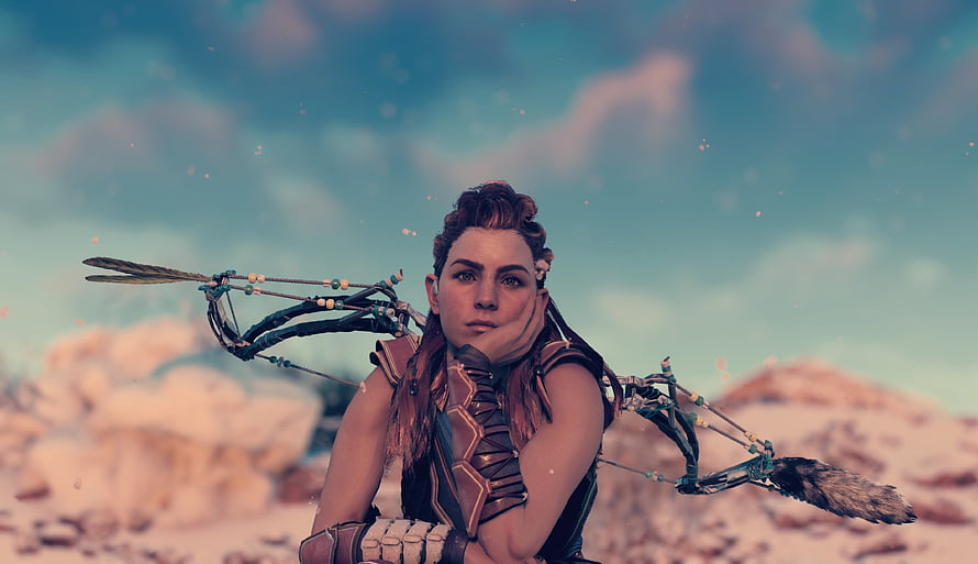 Aloy from Horizon Zero Dawn holding a bow in a desert landscape HD wallpaper