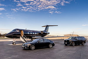 Luxury Private Jet and Black Luxury Cars Parked on Airport Tarmac at Sunset HD wallpaper
