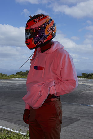 Frank Ocean Wearing A Colorful Racing Helmet On A Race Track HD phone wallpaper