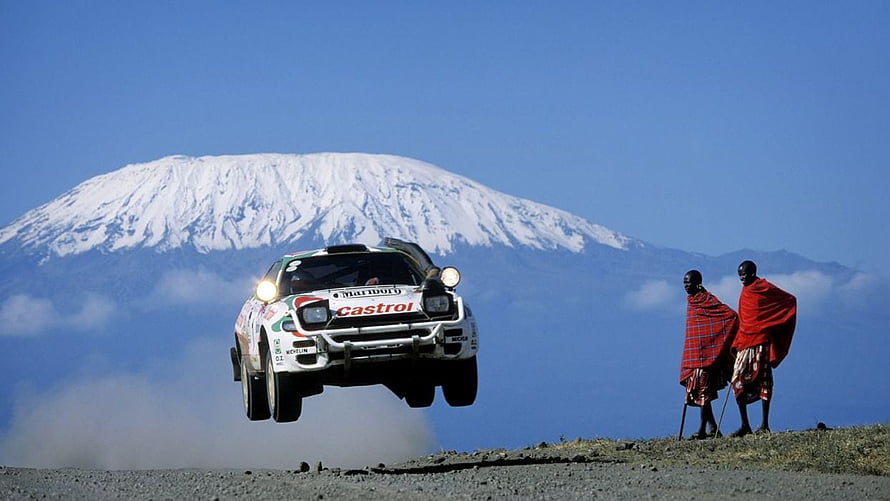 Toyota Celica WRC Rally Car Airborne Over Maasai Warriors With Snow-Capped Kilimanjaro HD wallpaper