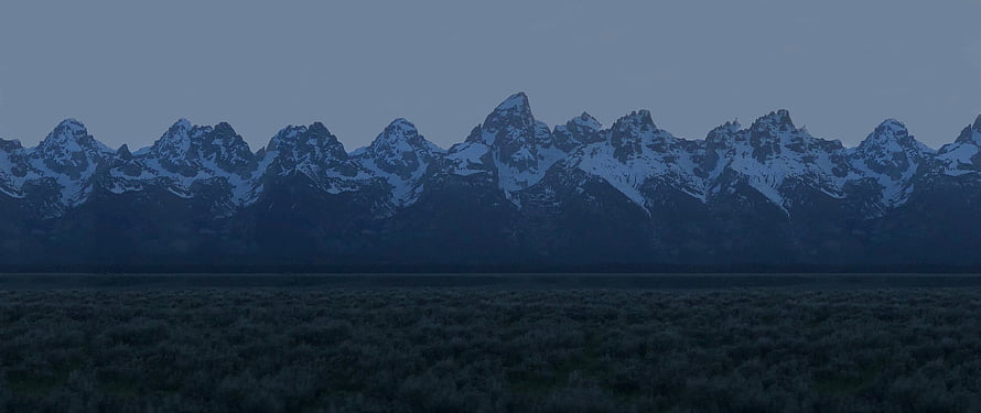Snow-Capped Mountain Range at Dusk with Dark Foreground Meadow HD wallpaper